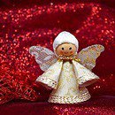 Wooden and Lace Christmas Angel Ornament with a red sparkly fabric in the background