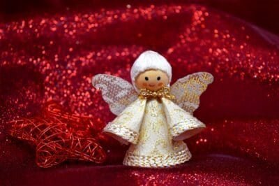 Wooden and Lace Christmas Angel Ornament with a red sparkly fabric in the background