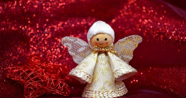 Wooden and Lace Christmas Angel Ornament with a red sparkly fabric in the background