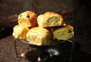 A plate of freshly baked, hot cross buns