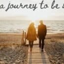 couple walking toward the beach holding hands