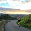 An athlete running alone on a lonley road