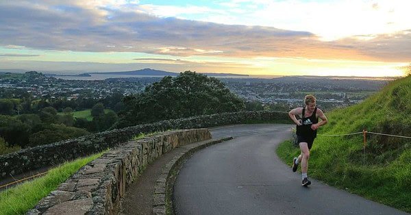 An athlete running alone on a lonley road