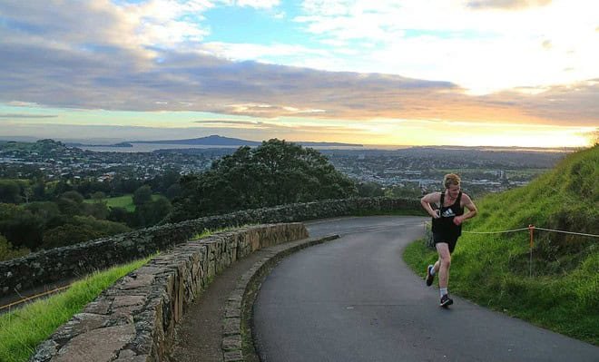 An athlete running alone on a lonley road