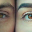 A man's left eye and a woman's right eye side by side.