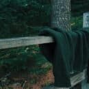 discarded sweater draped over a fence