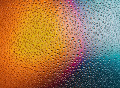 Rain on glass with a gradient of light behind.