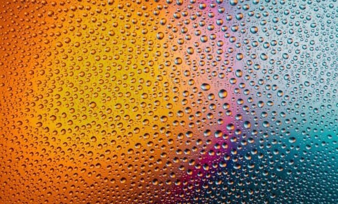 Rain on glass with a gradient of light behind.