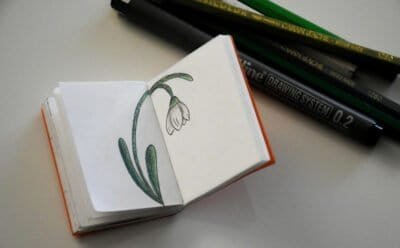 Mini unlined notebook with a flower illustration.
