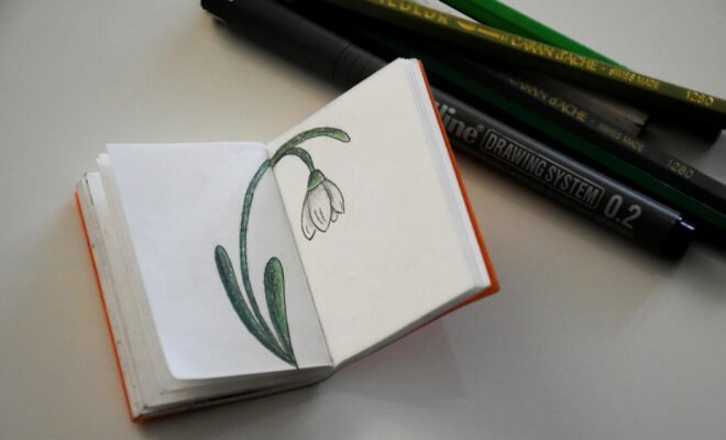 Mini unlined notebook with a flower illustration.