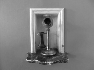 Black and white photo of a candlestick telephone