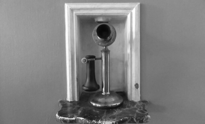 Black and white photo of a candlestick telephone