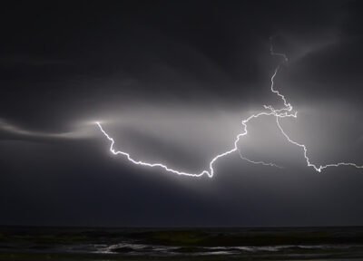 A thunderstorm over the ocean at night
