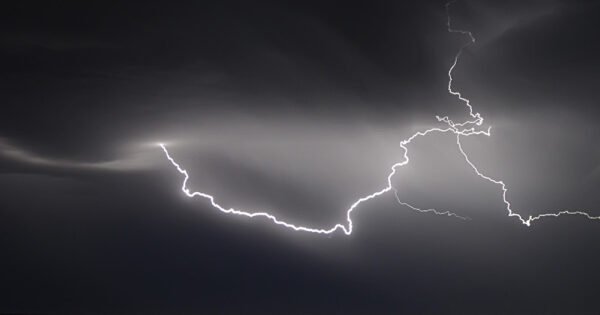 A thunderstorm over the ocean at night