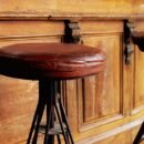 Old leather stools in front of a bar