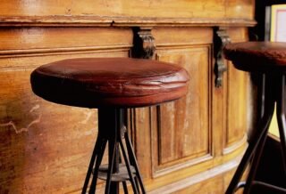 Old leather stools in front of a bar