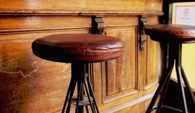 Old leather stools in front of a bar