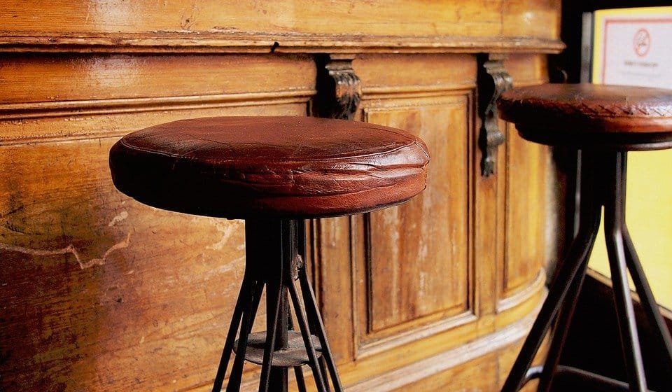Old leather stools in front of a bar