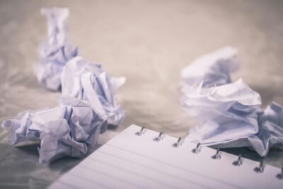 A notebook and crumpled papers on a light background