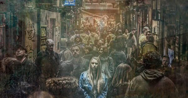 A lone woman in a busy, mass crowds in the city