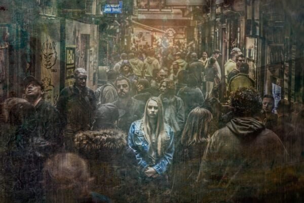A lone woman in a busy, mass crowds in the city