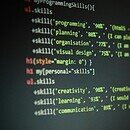 Computer screen showing programming codes with personal skills written within the lines of the code, including creativity, learning, and communication.
