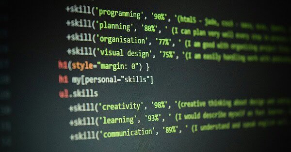 Computer screen showing programming codes with personal skills written within the lines of the code, including creativity, learning, and communication.