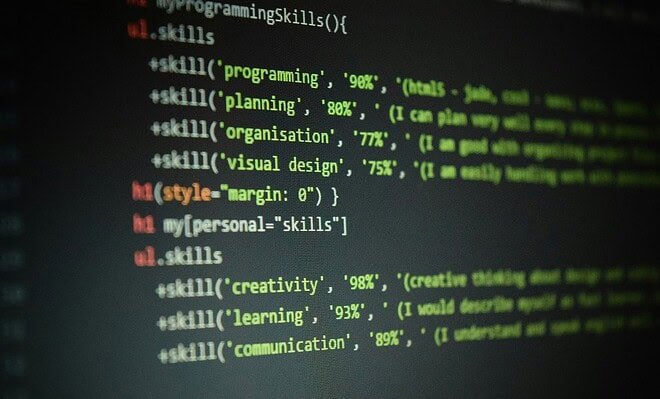 Computer screen showing programming codes with personal skills written within the lines of the code, including creativity, learning, and communication.