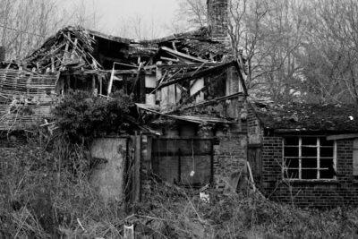Black and white photo of a dilapidated house