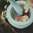 a mortar and pestle with spices inside