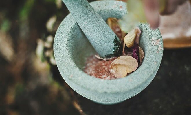 a mortar and pestle with spices inside