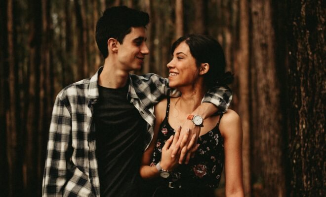 a couple in a side embrace, smiling at each other
