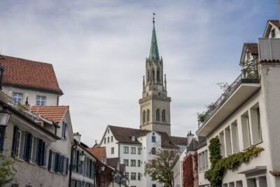 A lone church building in a cluster of houses and buildings