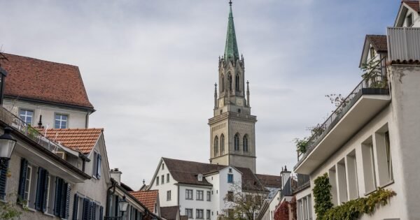 A lone church building in a cluster of houses and buildings