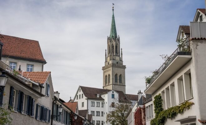 A lone church building in a cluster of houses and buildings