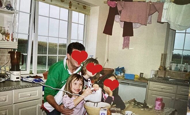 A little girl grinning ecstatically as she whisks up a concoction. Her family are with her and their faces are obscured for privacy.