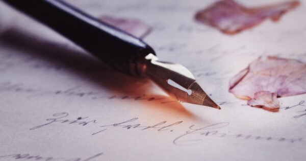 A quilled pen on top of marked paper