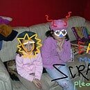 'Eat My Scraps. Please' is written on a photograph of two young girls. They do not look happy. Someone has doodled over their faces to maintain anonymity.