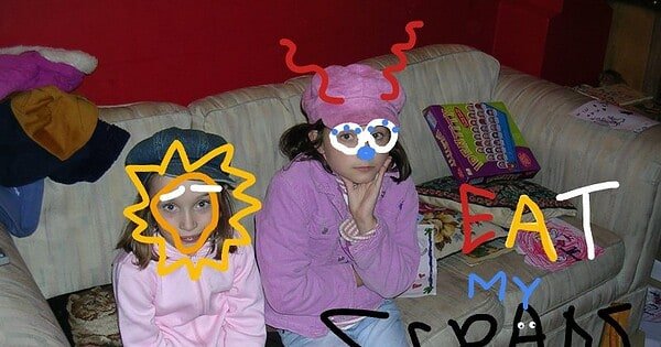 'Eat My Scraps. Please' is written on a photograph of two young girls. They do not look happy. Someone has doodled over their faces to maintain anonymity.