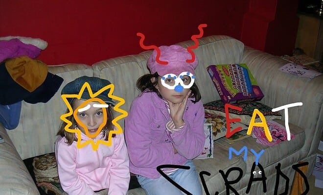 'Eat My Scraps. Please' is written on a photograph of two young girls. They do not look happy. Someone has doodled over their faces to maintain anonymity.