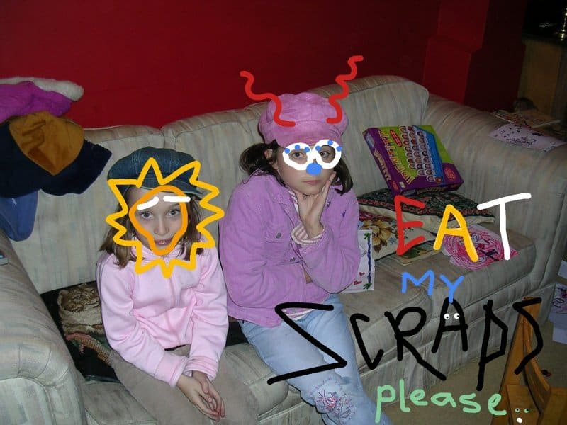 'Eat My Scraps. Please' is written on a photograph of two young girls. They do not look happy. Someone has doodled over their faces to maintain anonymity.