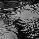 A street being pelted by falling raindrops