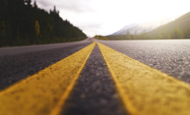 A outstretched paved road in a forest landscape