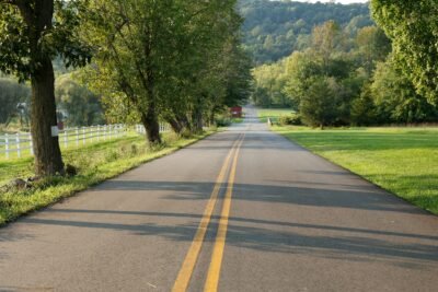 An empty road with trees by the sides.