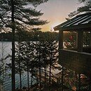 Image of a cabin in Maine on the ocean overlooking a sunset