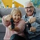 elderly man and woman playing video game.