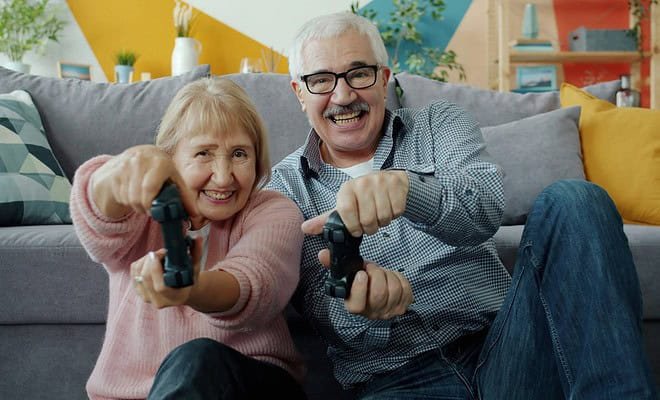 elderly man and woman playing video game.