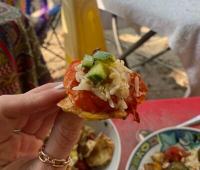 A small mouthful of food is held up to the camera.