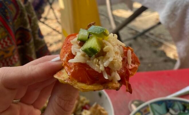 A small mouthful of food is held up to the camera.