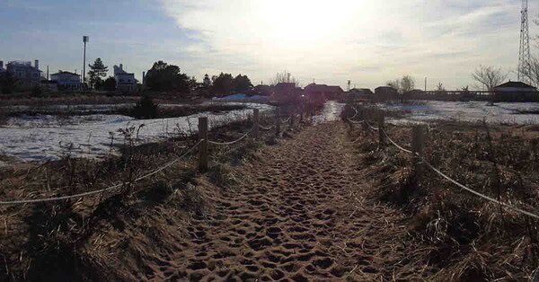 Image of a beach walkway as the sun is setting